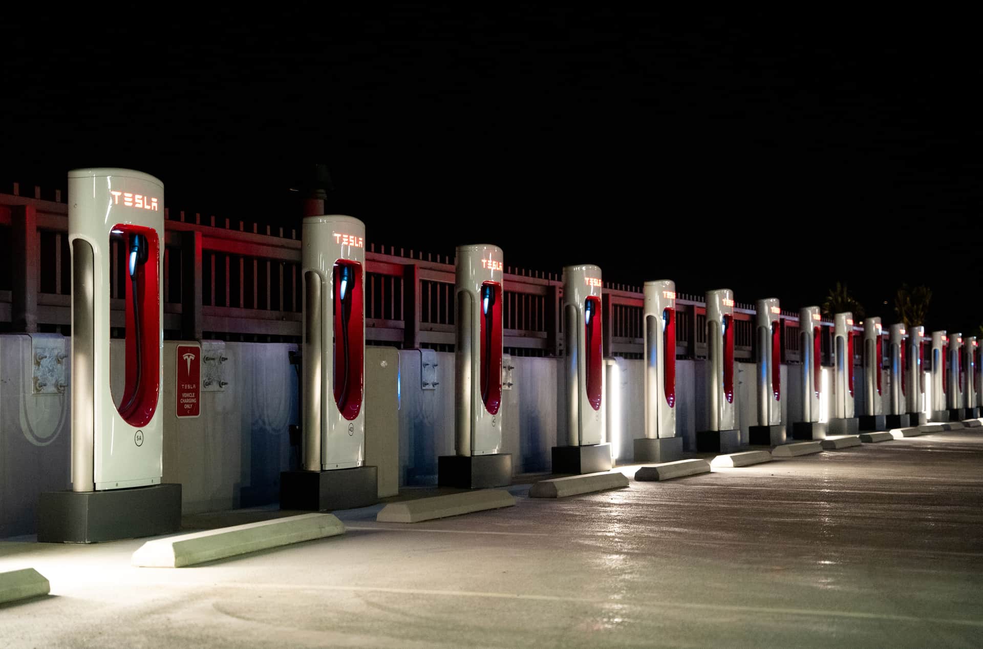 An electric car charging overnight in a home driveway